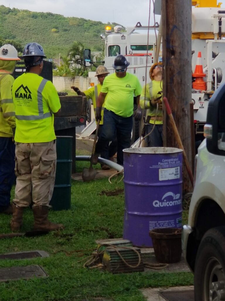 Mana crew at a utility pole with a bucket truck