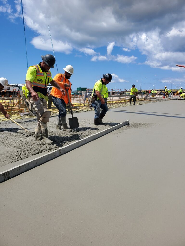 Mana crew finishing a new concrete sidewalk
