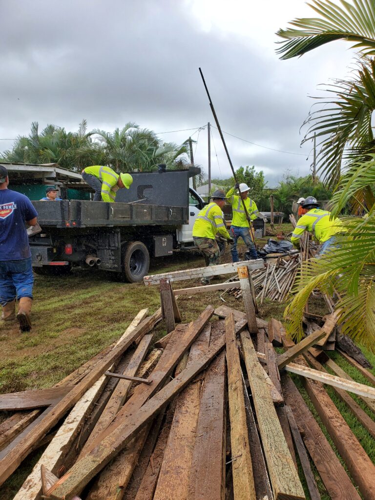 Mana crew working beside a crew truck on a job site